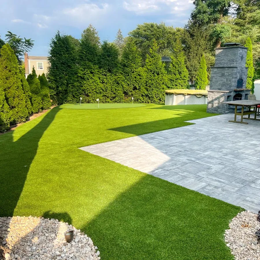 a backyard with a stone patio
