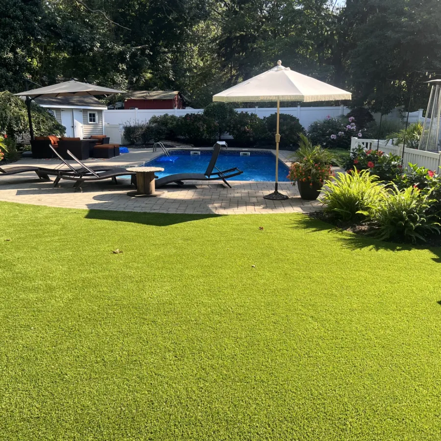 a backyard with a pool and umbrella