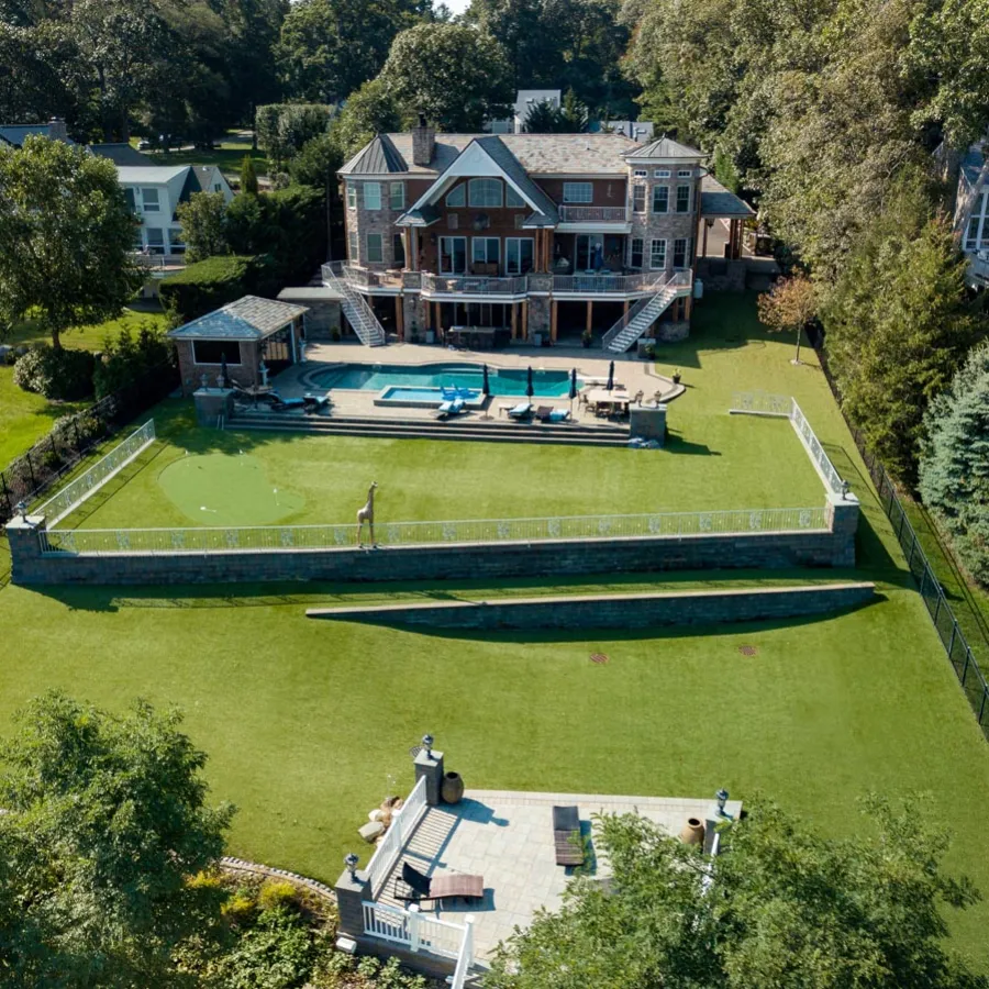 a large house with a pool in the front