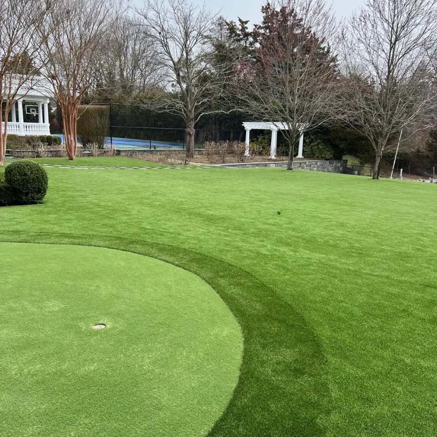 a large grassy area with trees in the background