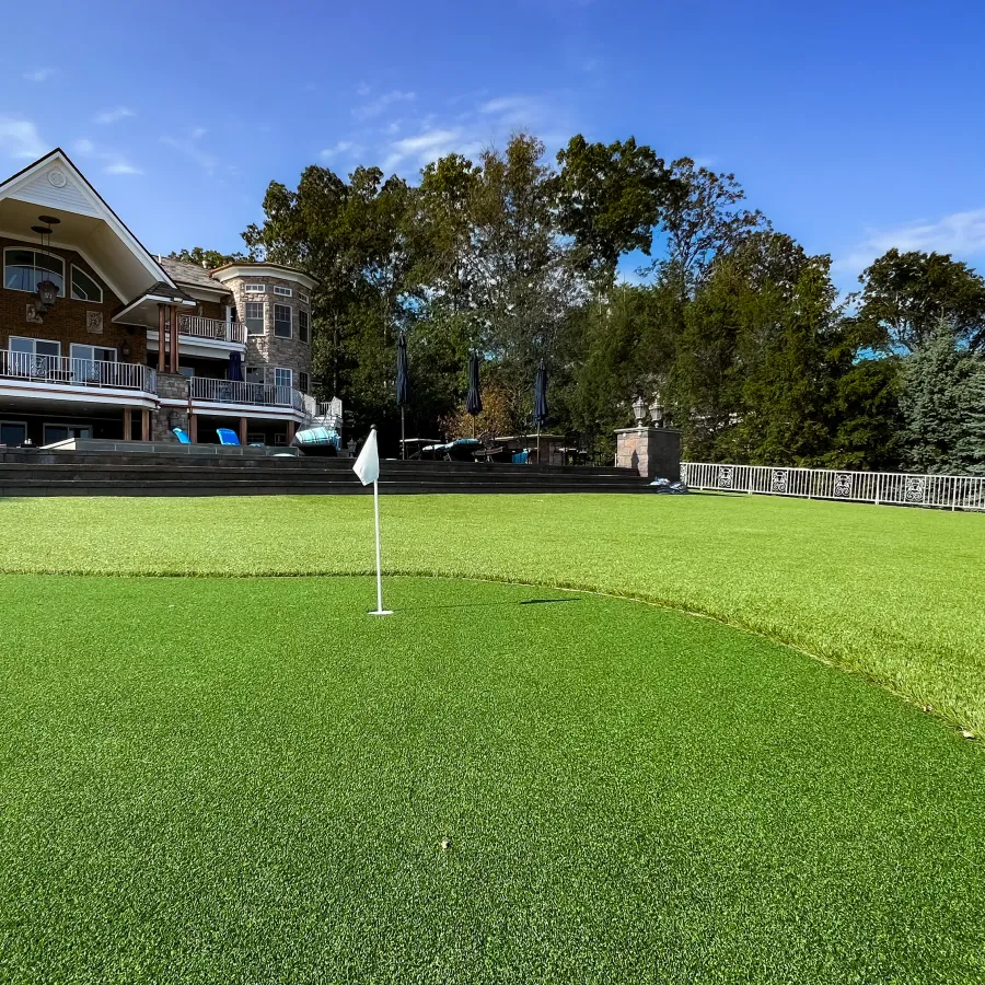 a golf course with a building in the background