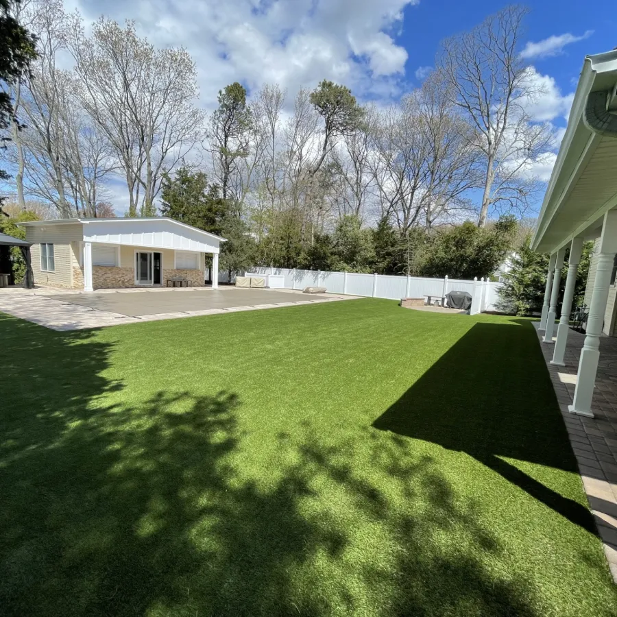 a yard with a fence and a house