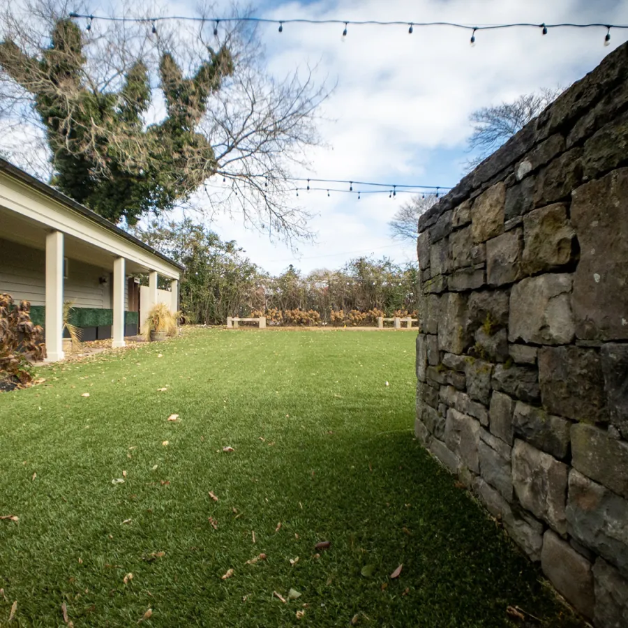 a stone wall and a house