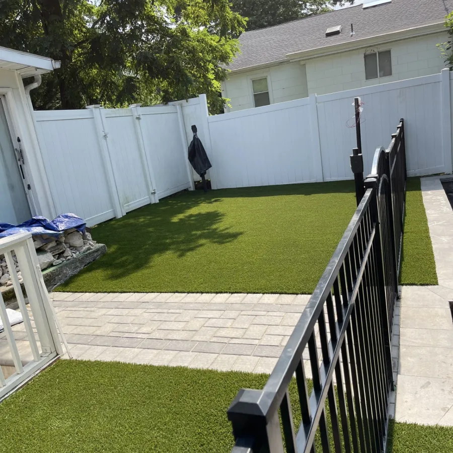 a fenced in yard with a white house and trees