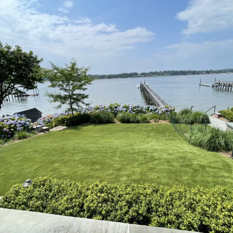 a grassy area with a body of water in the background