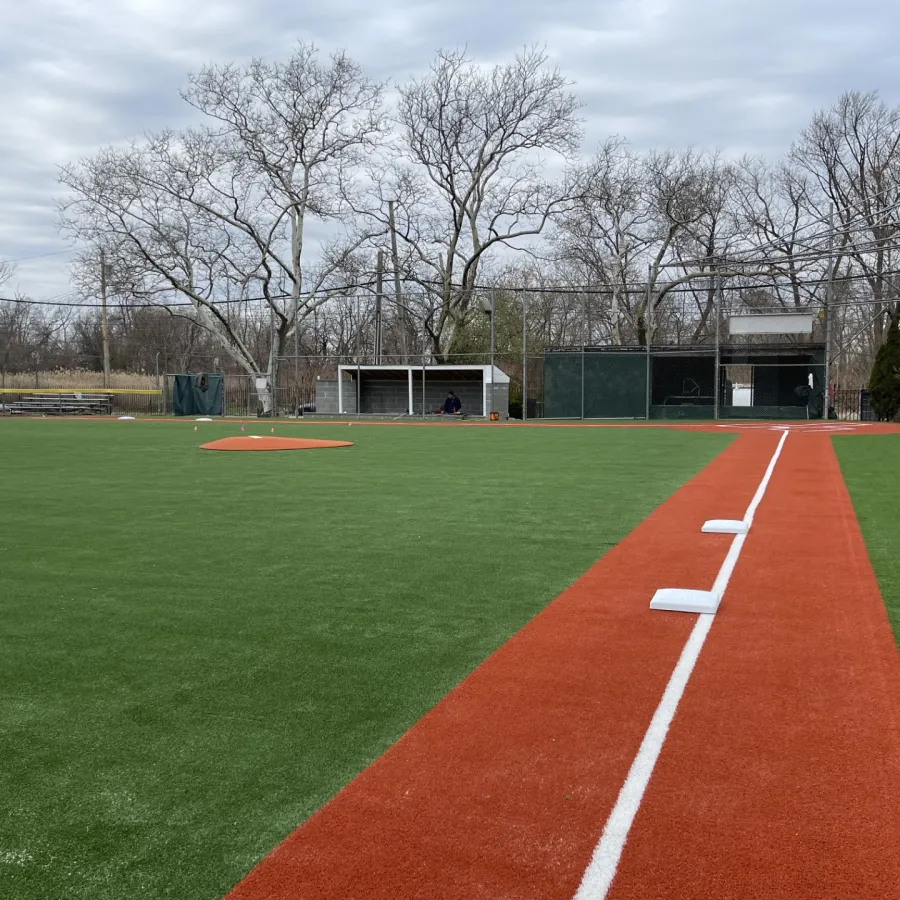 a sports field with a building in the background