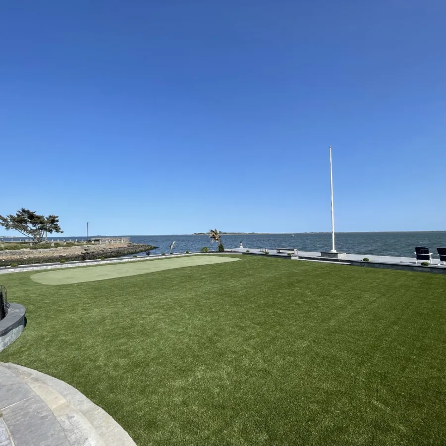 a golf course next to a body of water