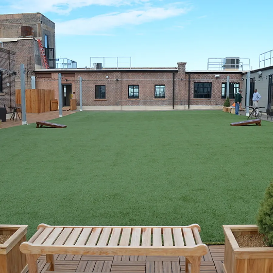 a park with benches and a building in the background