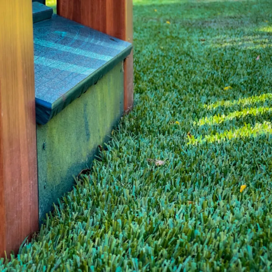 a grassy area with a wood structure