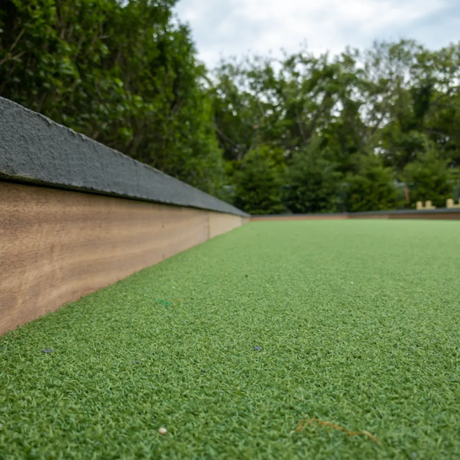 a grassy field with trees in the background