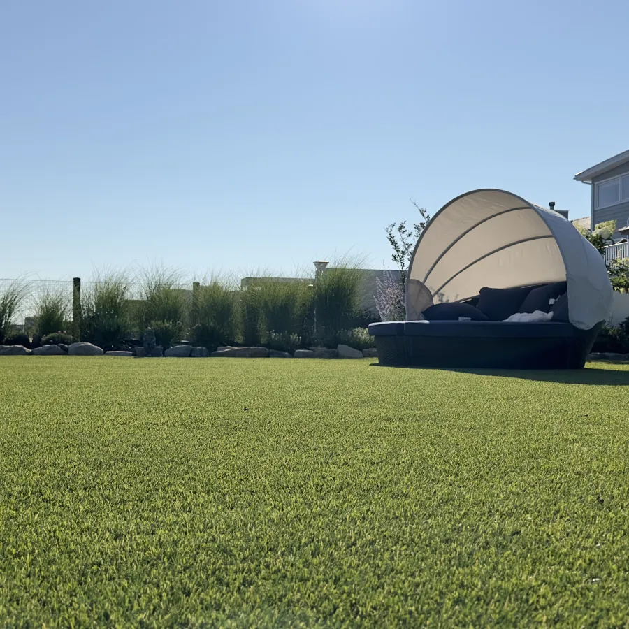 a large grass field with a building in the background