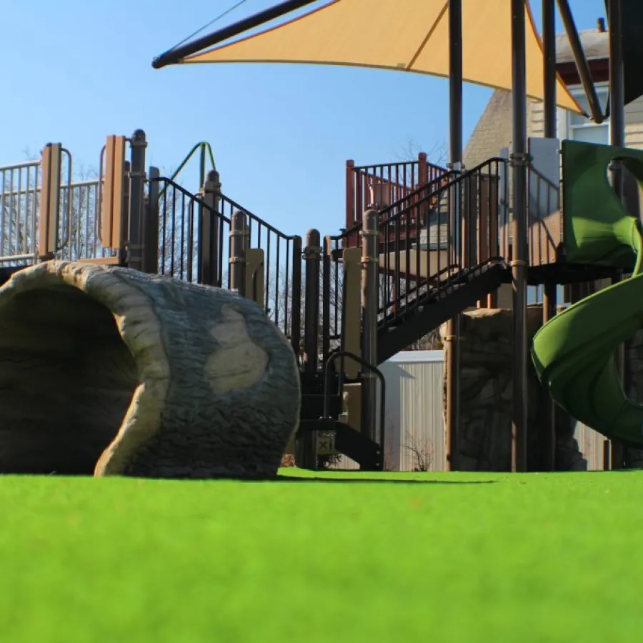 a large green slide in a yard