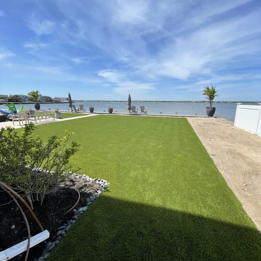 a grassy area with a body of water in the background