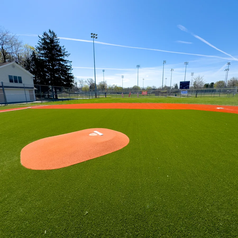 a baseball field with a red and white ball in the middle