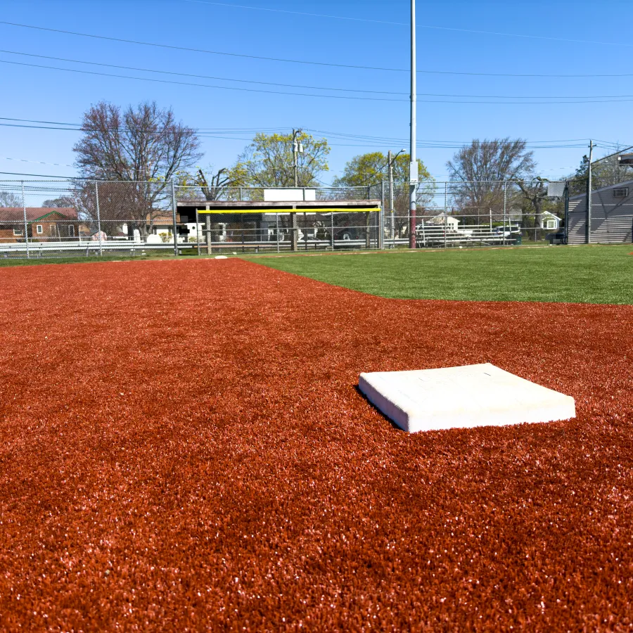 a baseball field with a white paper on the ground