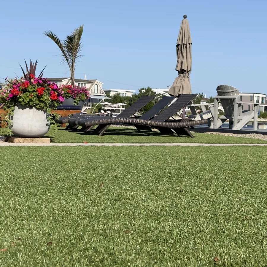 a grassy area with a statue in the background