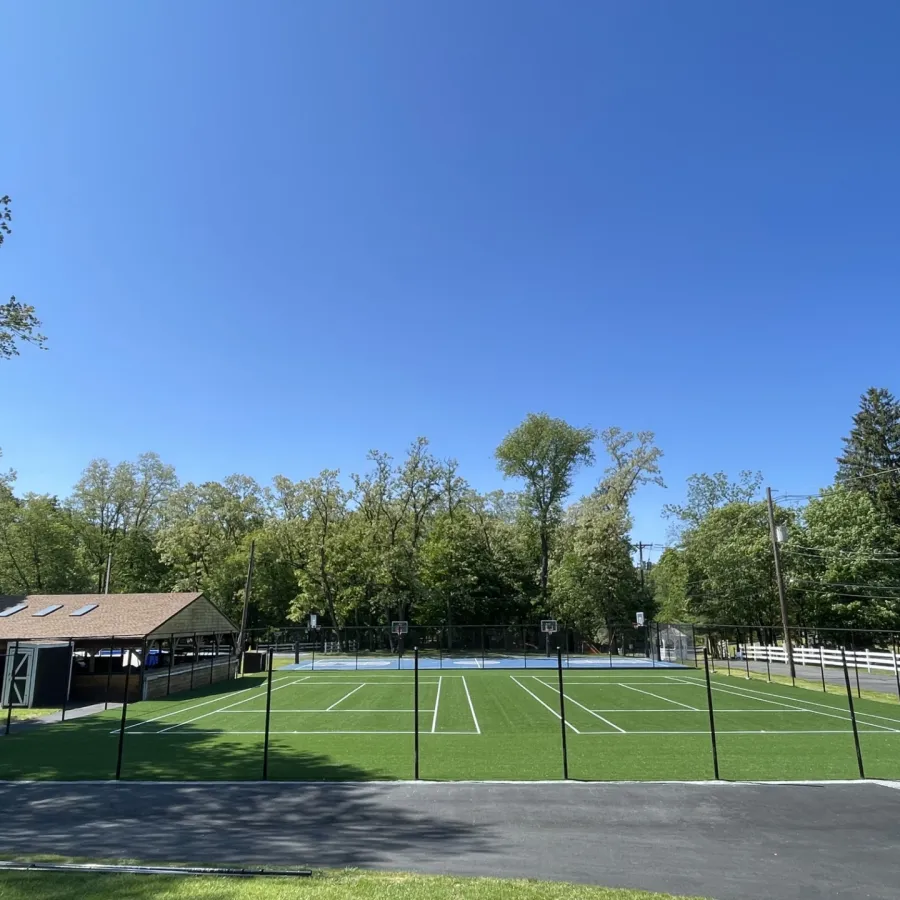 a tennis court with trees in the background