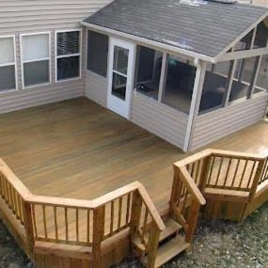 Spacious wooden deck with railing and steps attached to a house with a small enclosed porch.