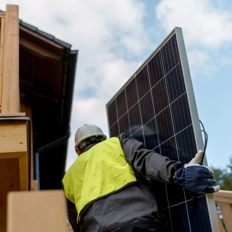 a person wearing a hard hat and protective gear working on a roof