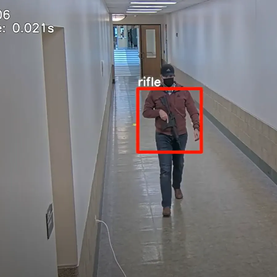 a person in a garment walking down a hallway