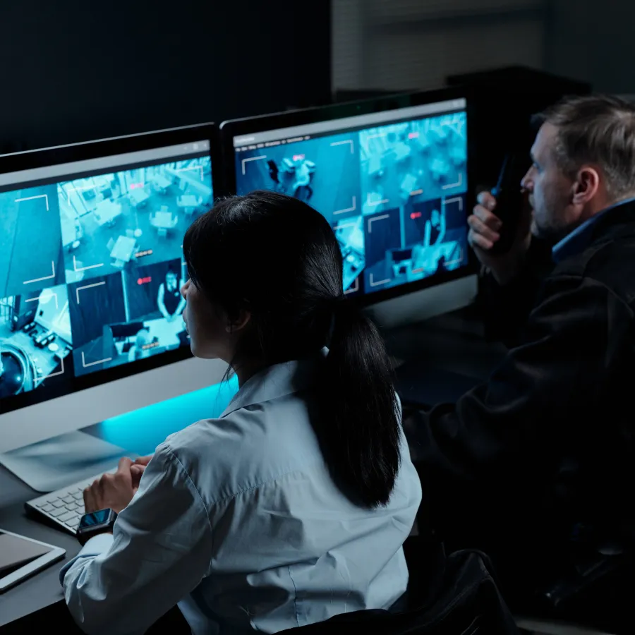 a man and a woman looking at a computer screen