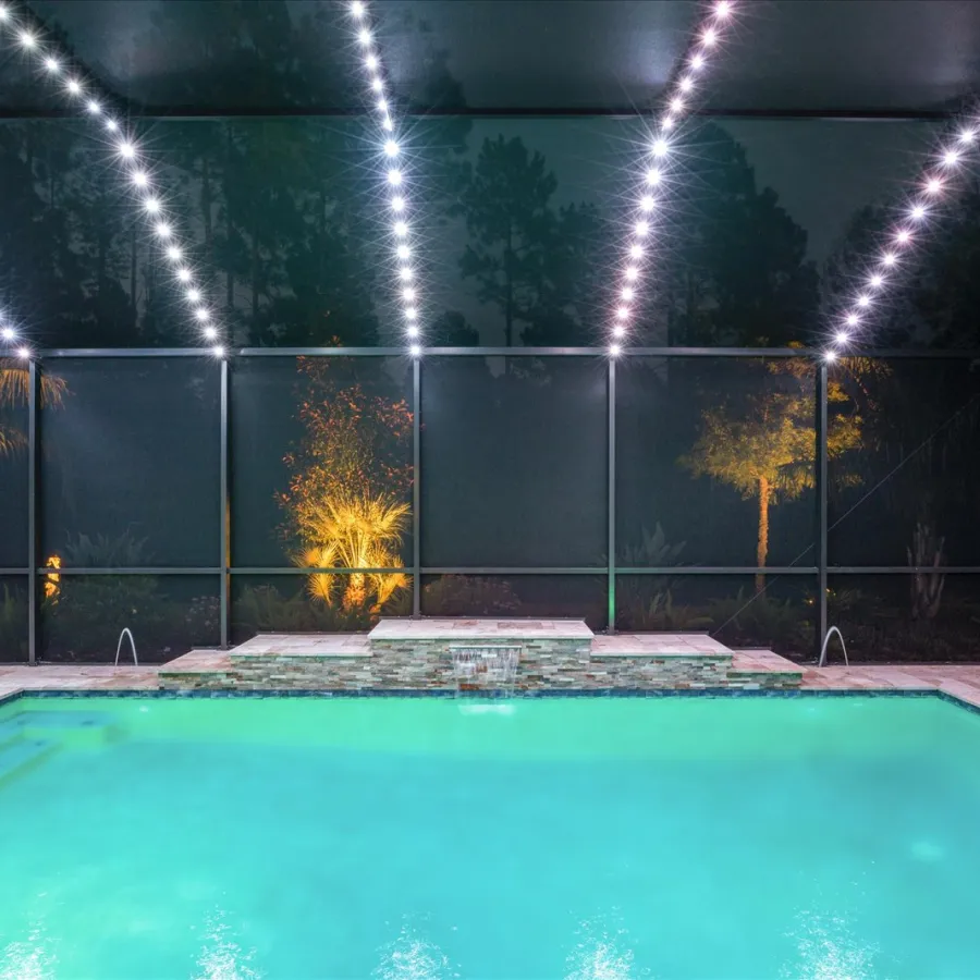 a pool with trees and lights