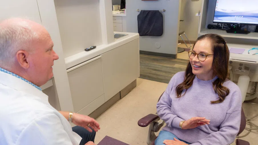 Dentist consulting a female patient in a dental office during a check-up appointment