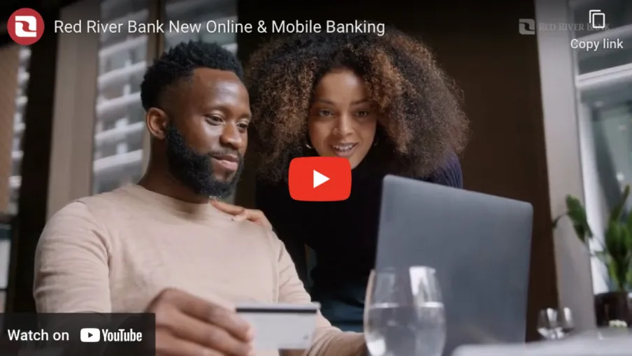 a man and a woman looking at a laptop