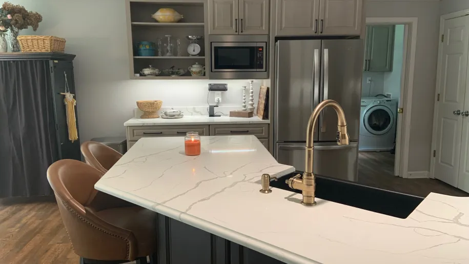 Peninsula with brass faucet and quartz counters