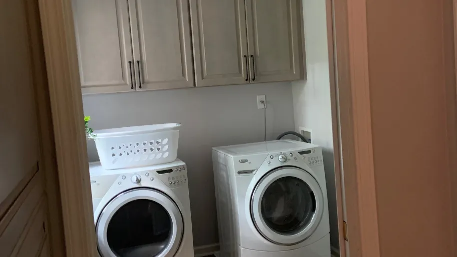 Laundry room with matching upper cabinets