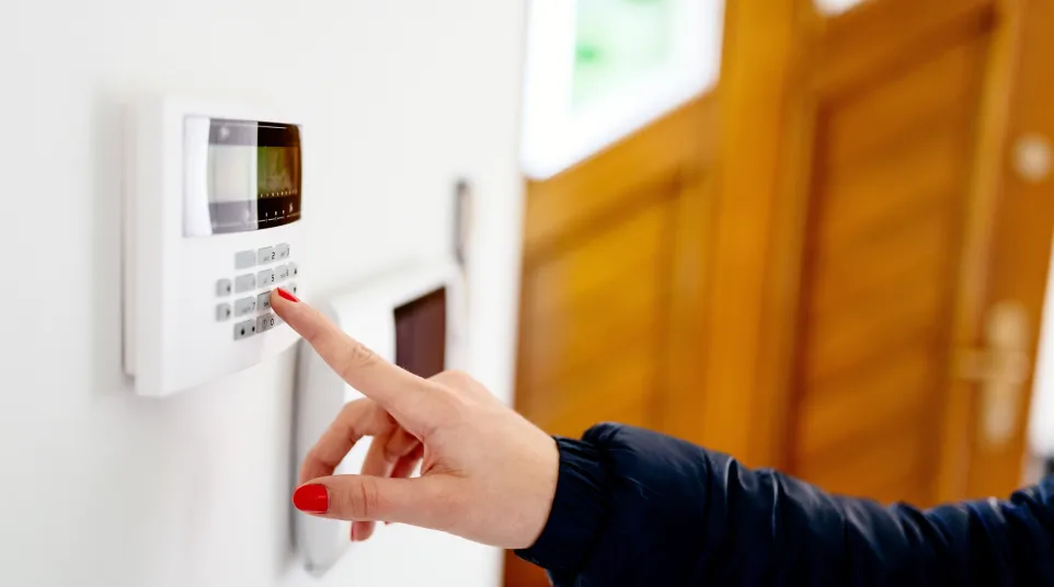 a hand pointing at a keypad