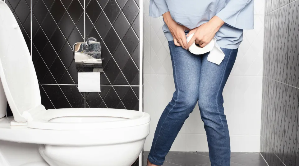 a person standing next to a toilet