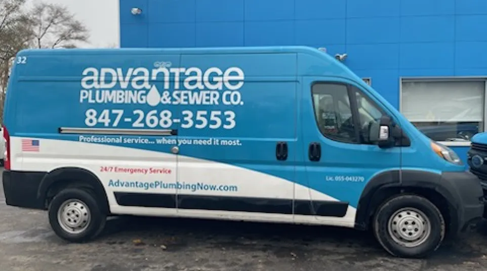 Blue and white Advantage Plumbing & Sewer Co. service van parked outside a blue building with contact details visible.