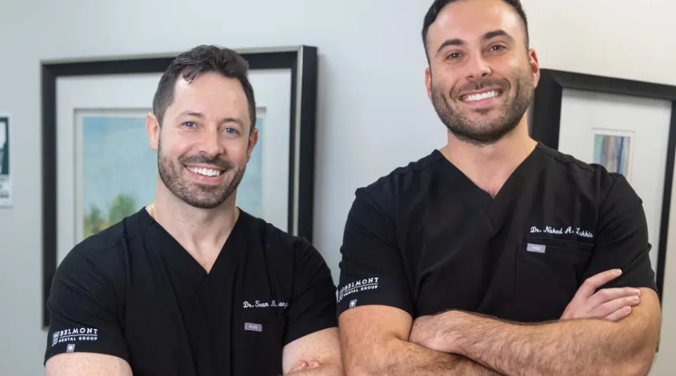 Dr. Nahed A. Lakkis with Dr. Sean M. Langton posing cross-armed inside Belmont Dental Group office