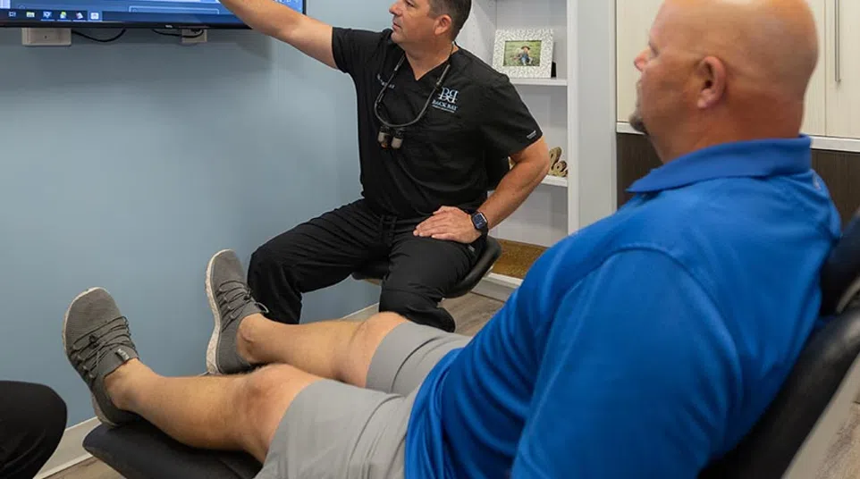 Dr. Jeremy Parker explains dental X-ray on screen to patient