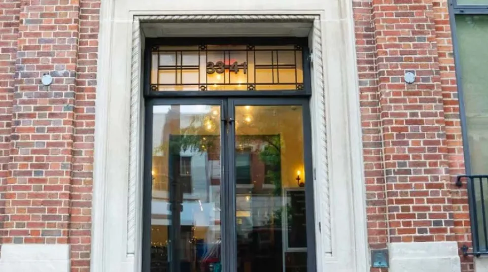 Entrance to River View Historical Plaza II with glass double doors in a brick building