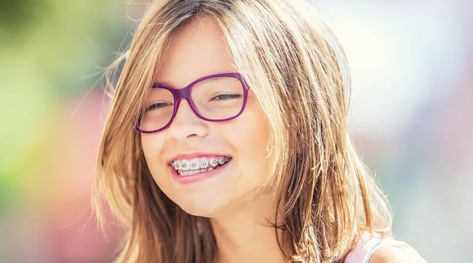 a woman with glasses smiling