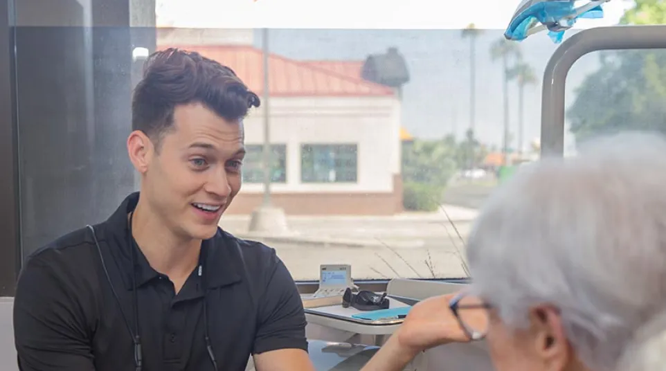 Dental professional talking with a relaxed patient seated in a dental chair during a consultation.