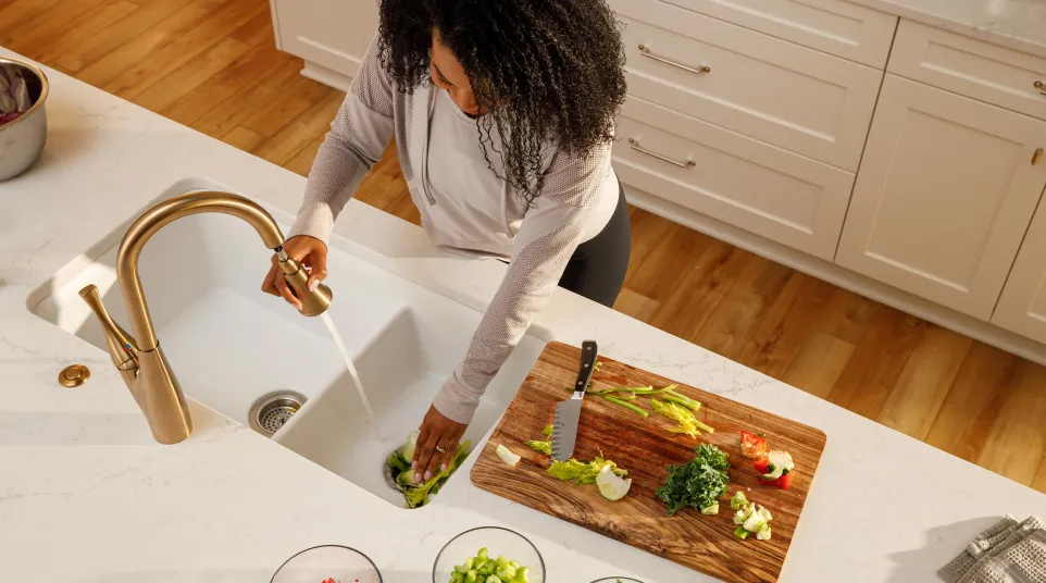 a person washing dishes in the kitchen