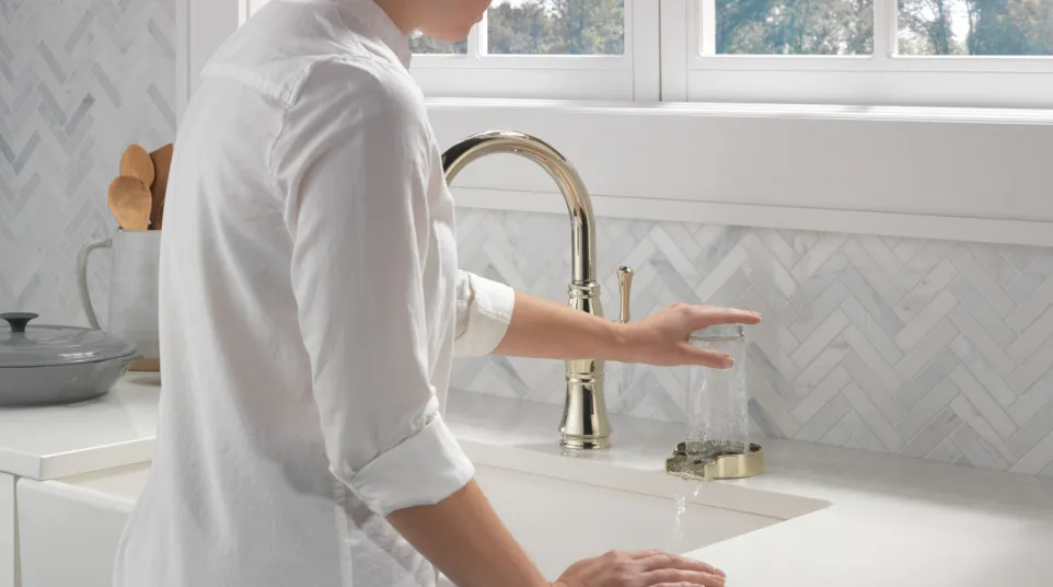 a person washing the hands in the sink