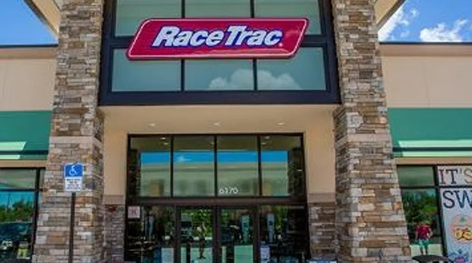 Exterior view of a RaceTrac convenience store with stone pillars and large glass entrance under a clear sky.