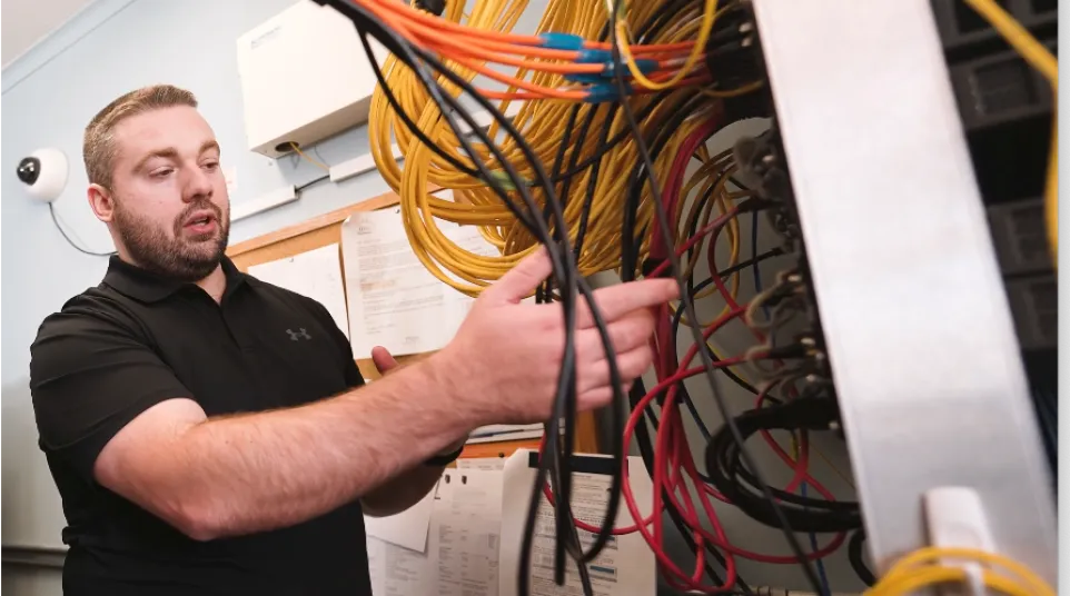 a man holding a yellow and black wire