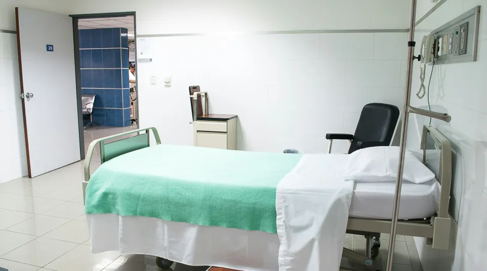 a hospital room with a bed and a chair