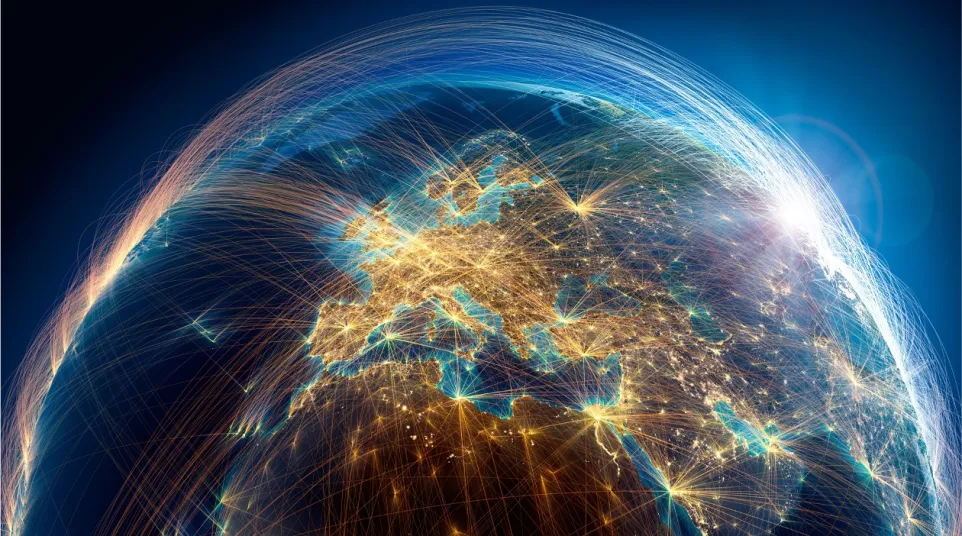Digital globe showing interconnected lines and bright city lights across Europe and surrounding regions at night.