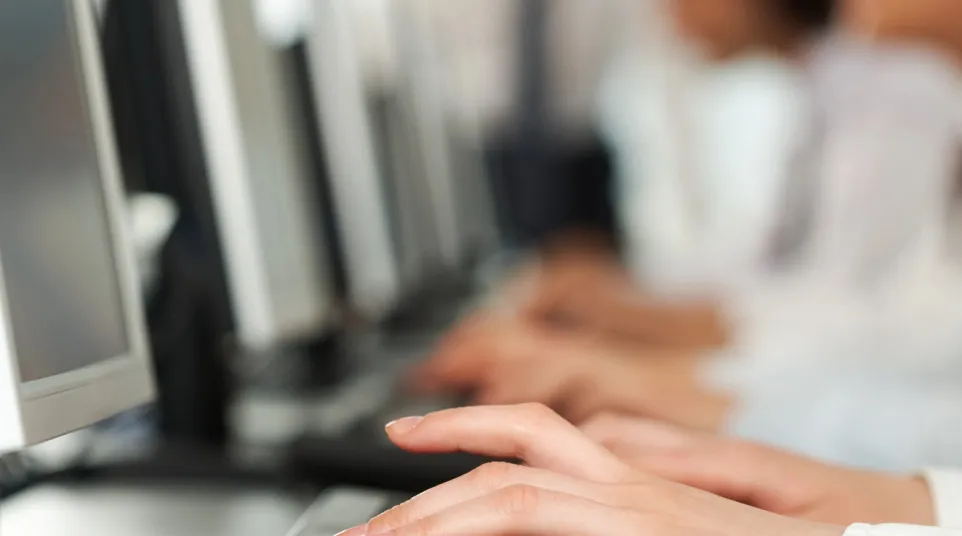 a close-up of a person typing on a keyboard