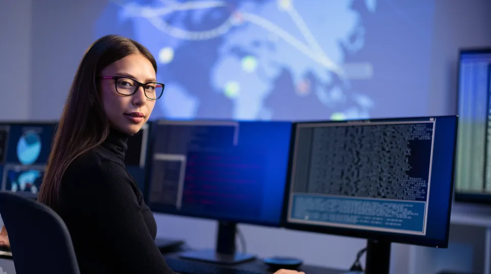 a woman sitting at a desk with a computer