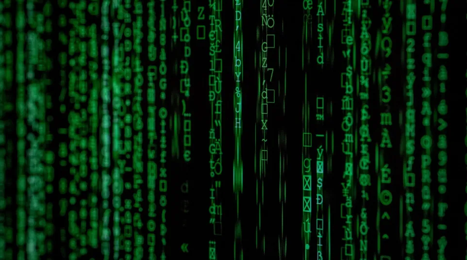 Green glowing matrix-style digital code cascading vertically on a black background representing data streams.