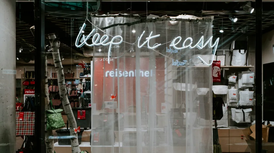 a store window with a display of shoes and bags