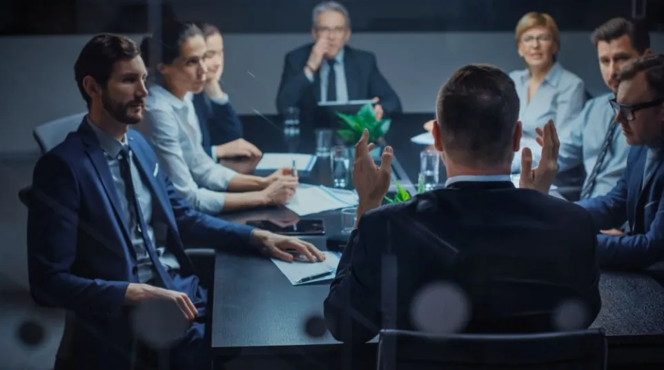 a group of people sitting around a table