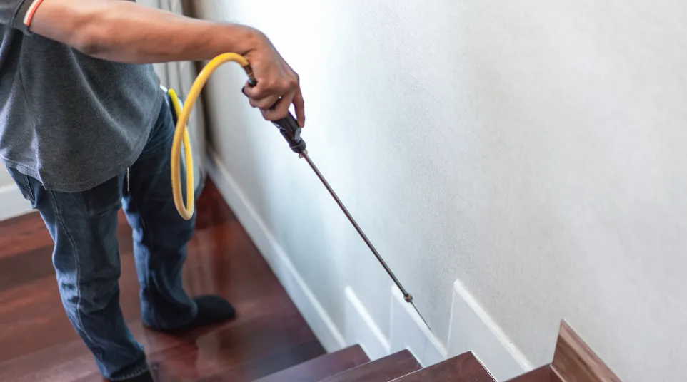 a man holding a yellow hose